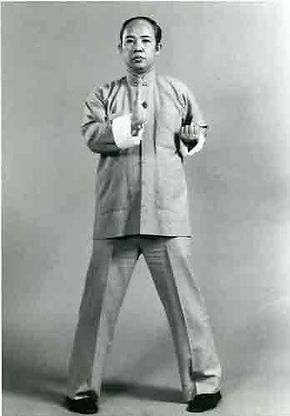 A black and white photo of a man in a karate pose.