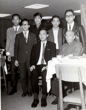 A group of men are posing for a picture in a restaurant.