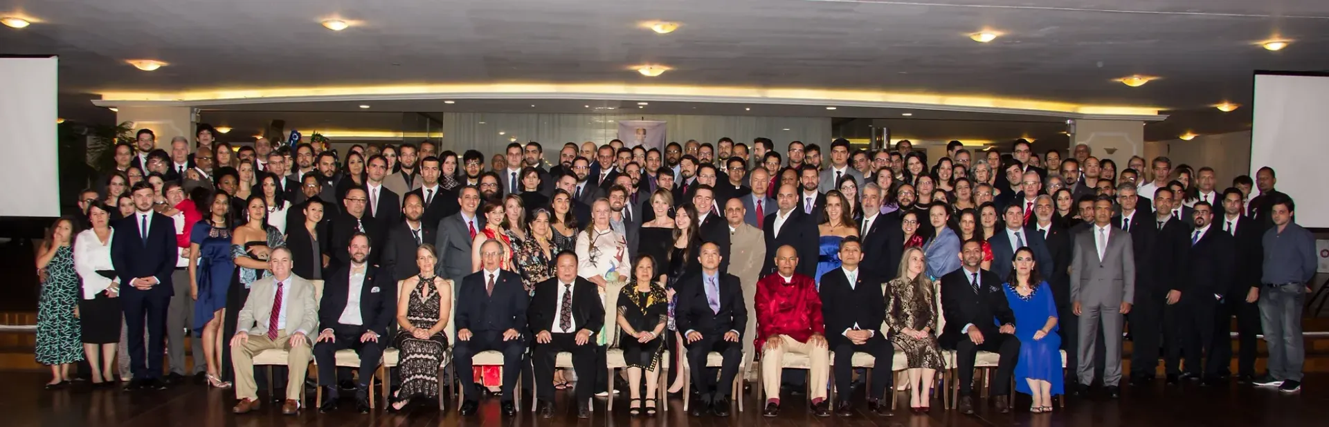 A large group of people are posing for a picture in a room.