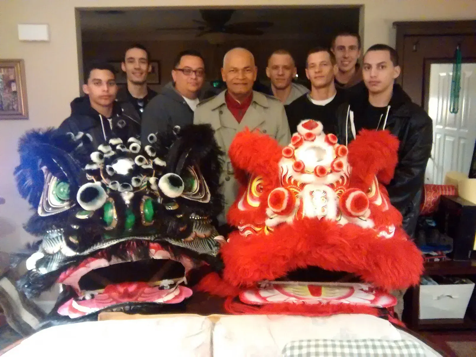 A group of men are posing for a picture with a lion costume