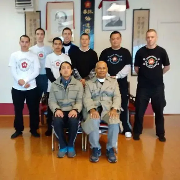 A group of men are posing for a picture in a room