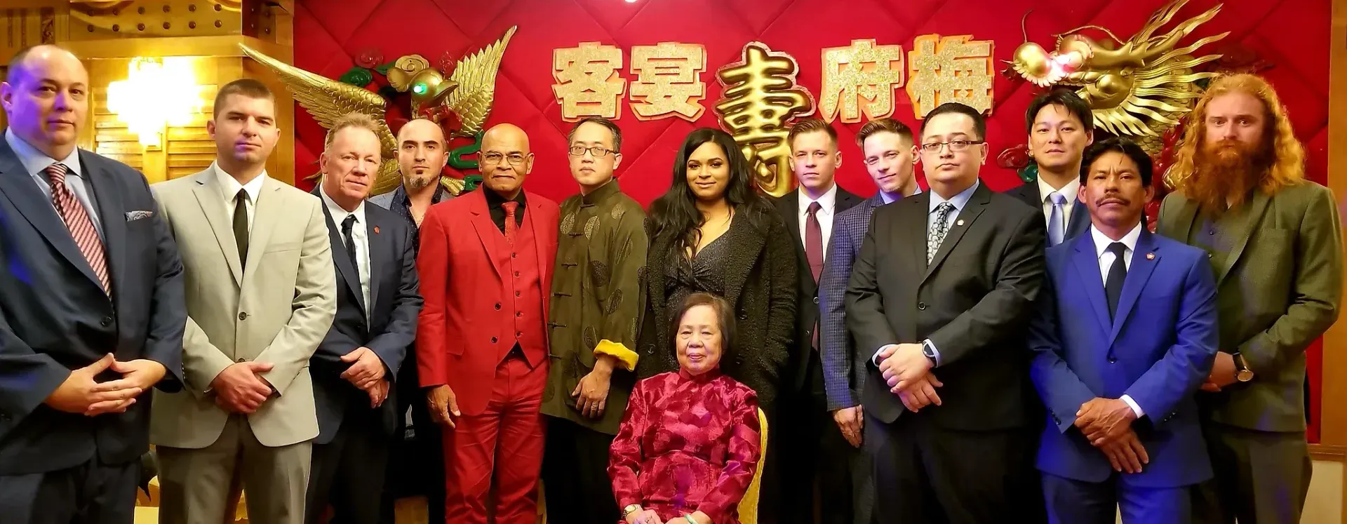 A group of people in suits and ties are posing for a picture.