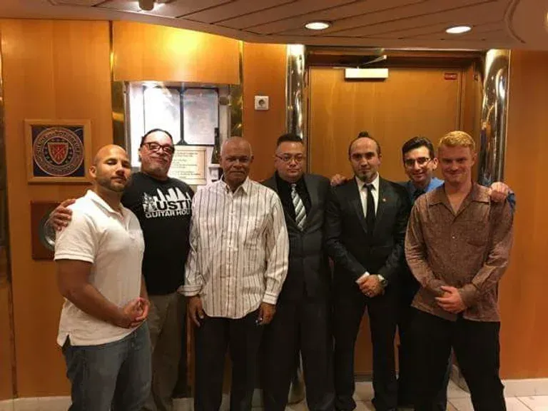 A group of men are posing for a picture in a room.