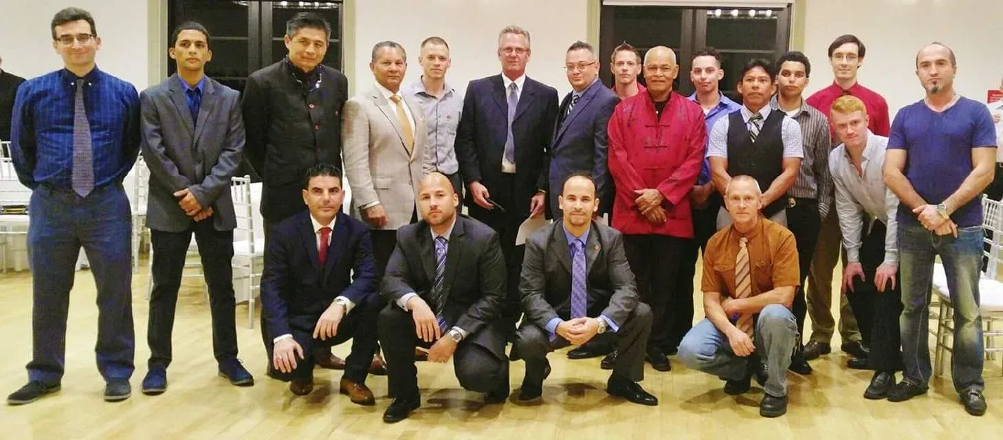 A group of men in suits and ties pose for a picture