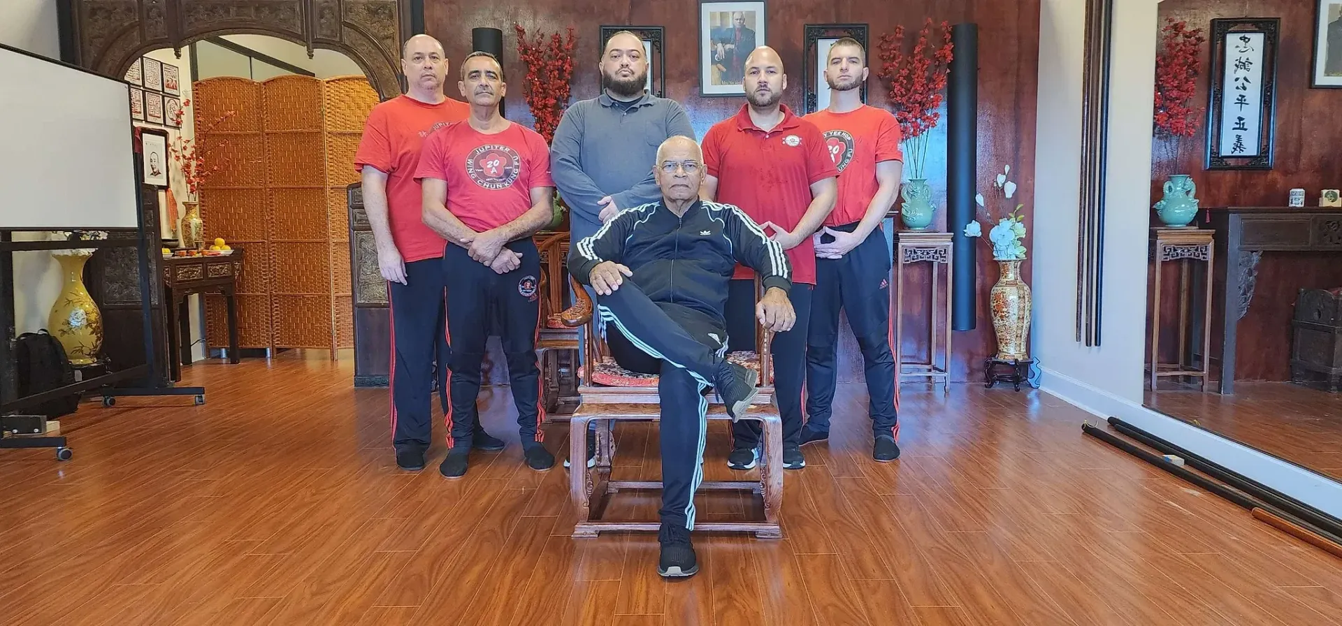 A group of men are posing for a picture in a room.