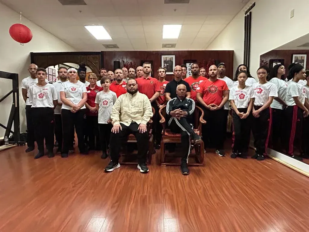 A group of people are posing for a picture in a gym.