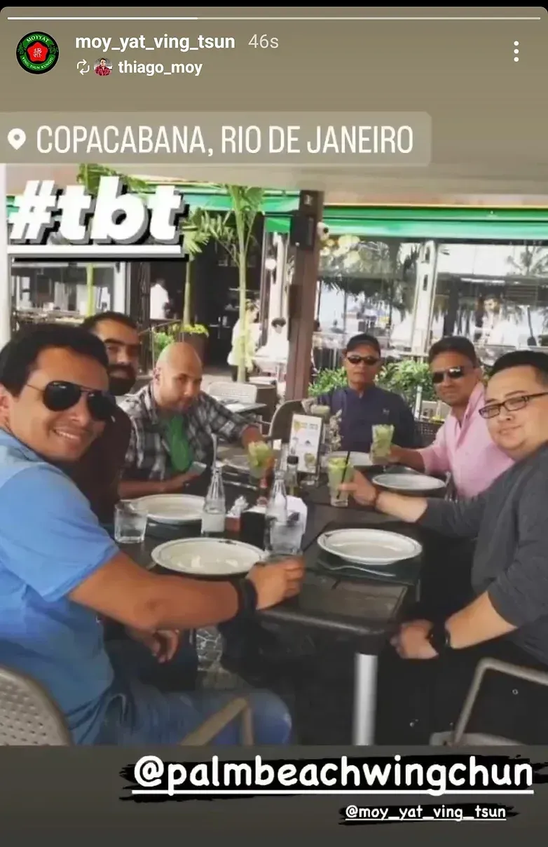 A group of men are sitting at a table in a restaurant.