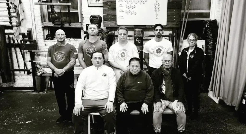A group of men are posing for a picture in a gym.