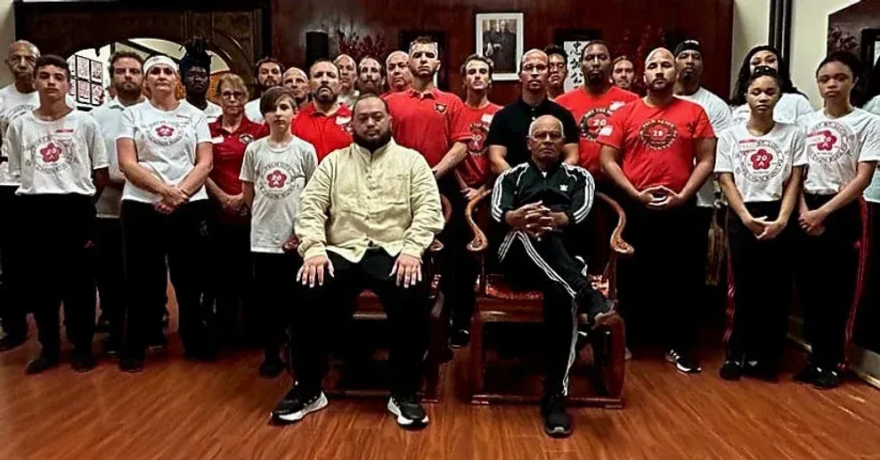 A group of people are posing for a picture in a room.