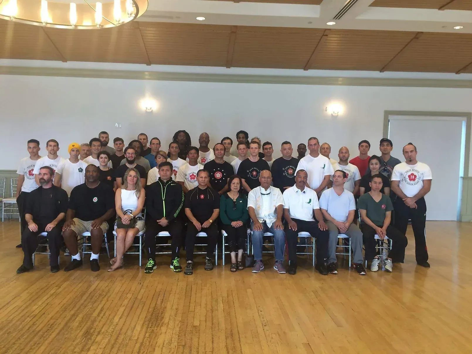 A large group of people are posing for a picture in a room.