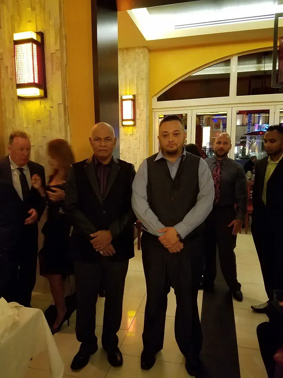 A group of men in suits and ties are standing in a room.