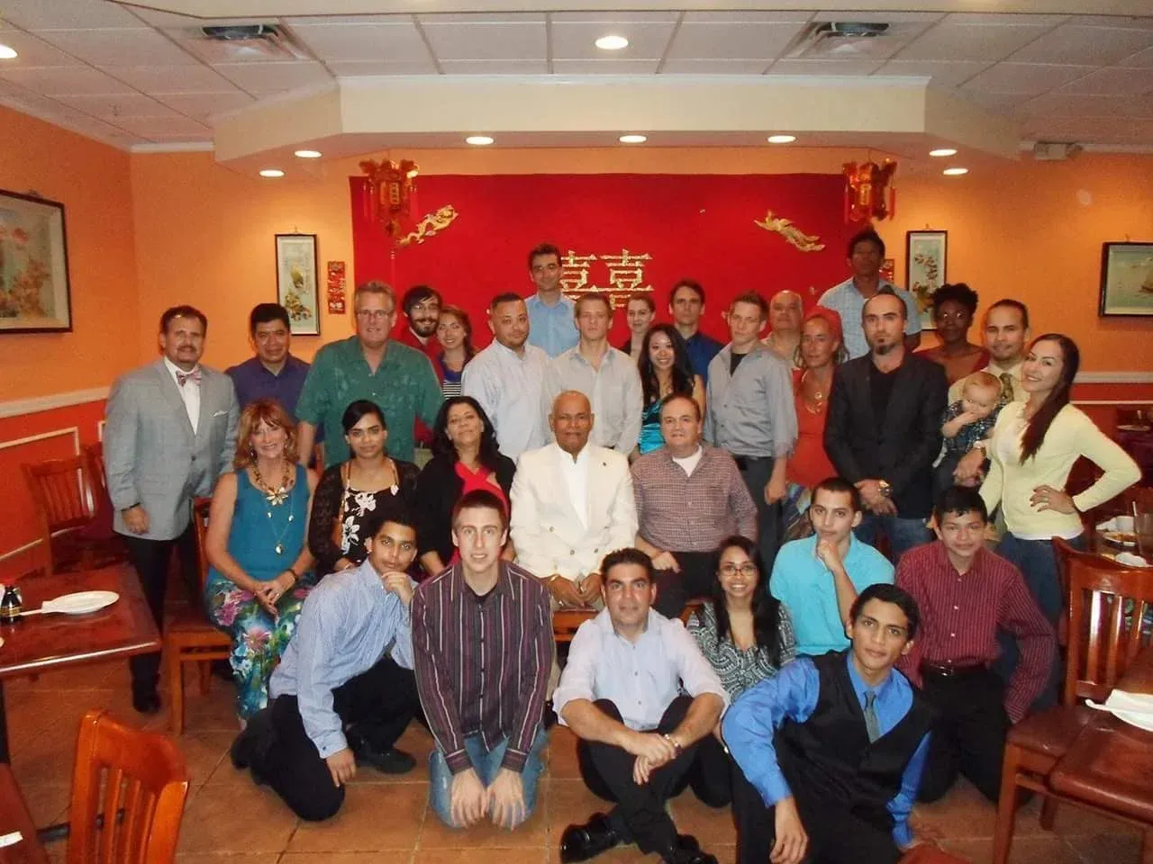 A large group of people posing for a picture in a restaurant