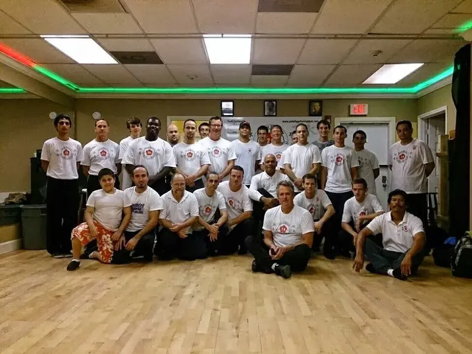 A group of people posing for a picture in a gym