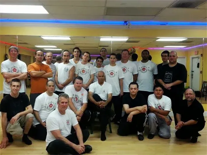 A group of men are posing for a picture in a gym