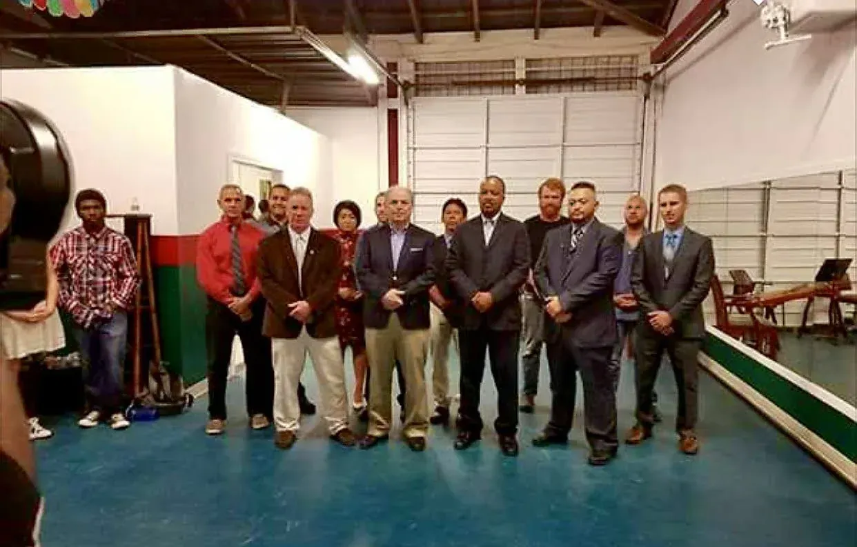 A group of people are posing for a picture in a room.