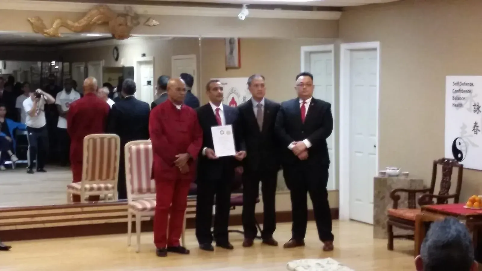 A group of men in suits and ties are standing in a room
