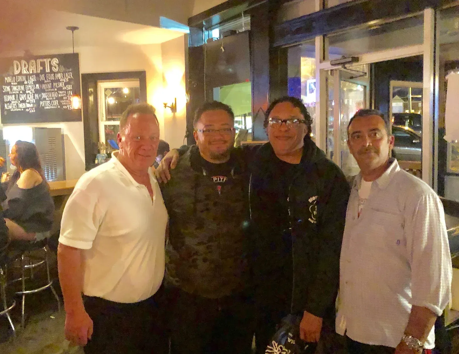 A group of men are posing for a picture in a restaurant.
