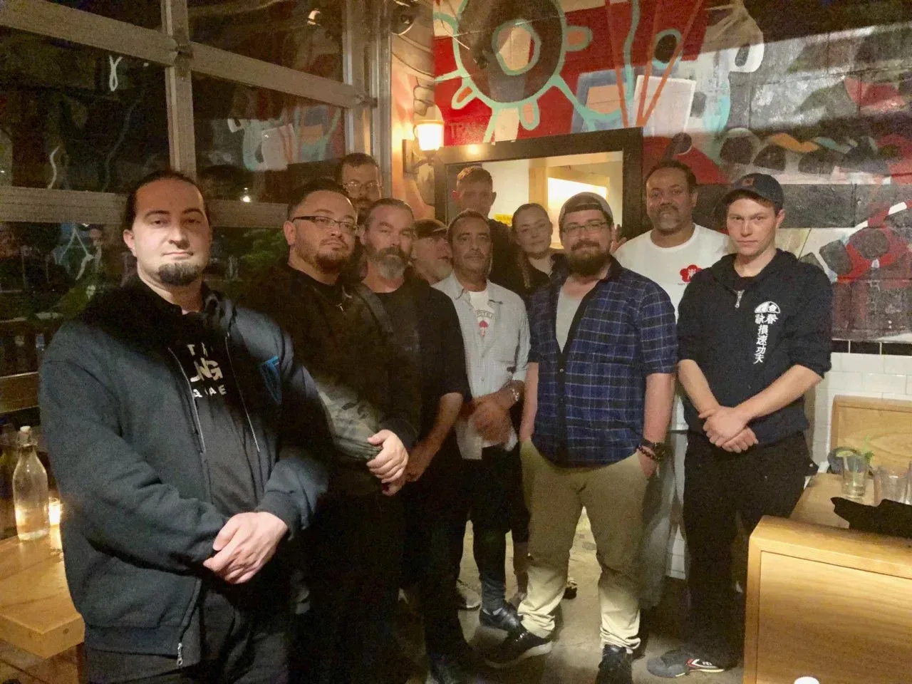 A group of men are posing for a picture in a room.