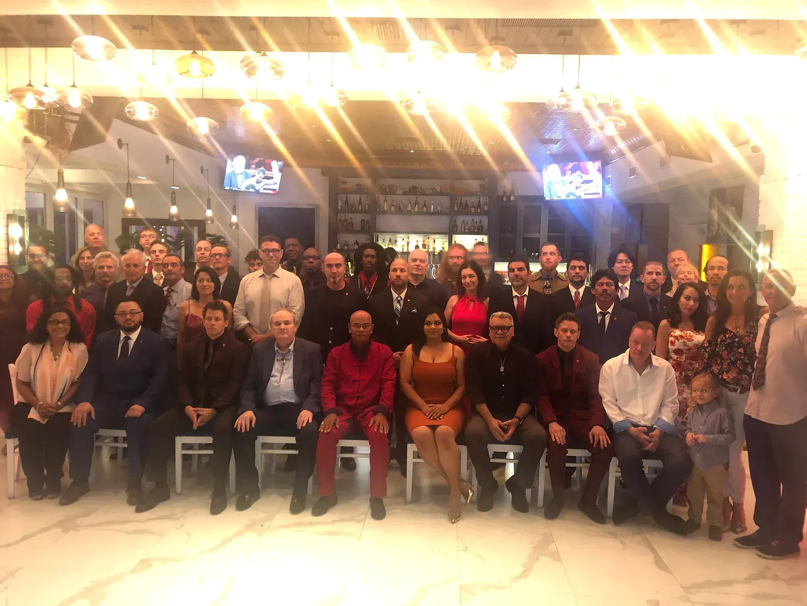 A large group of people are posing for a picture in a room.