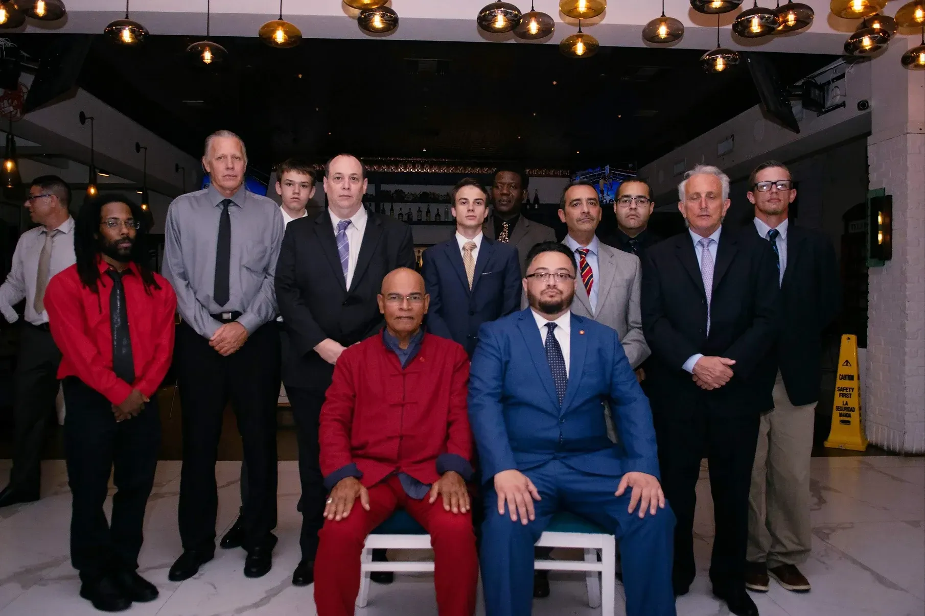 A group of men in suits and ties are posing for a picture.