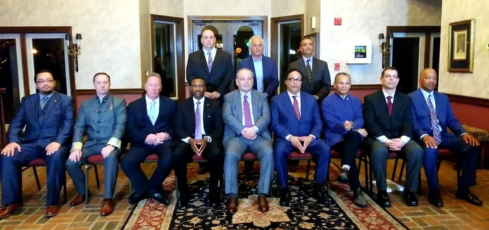 A group of men in suits and ties are posing for a picture