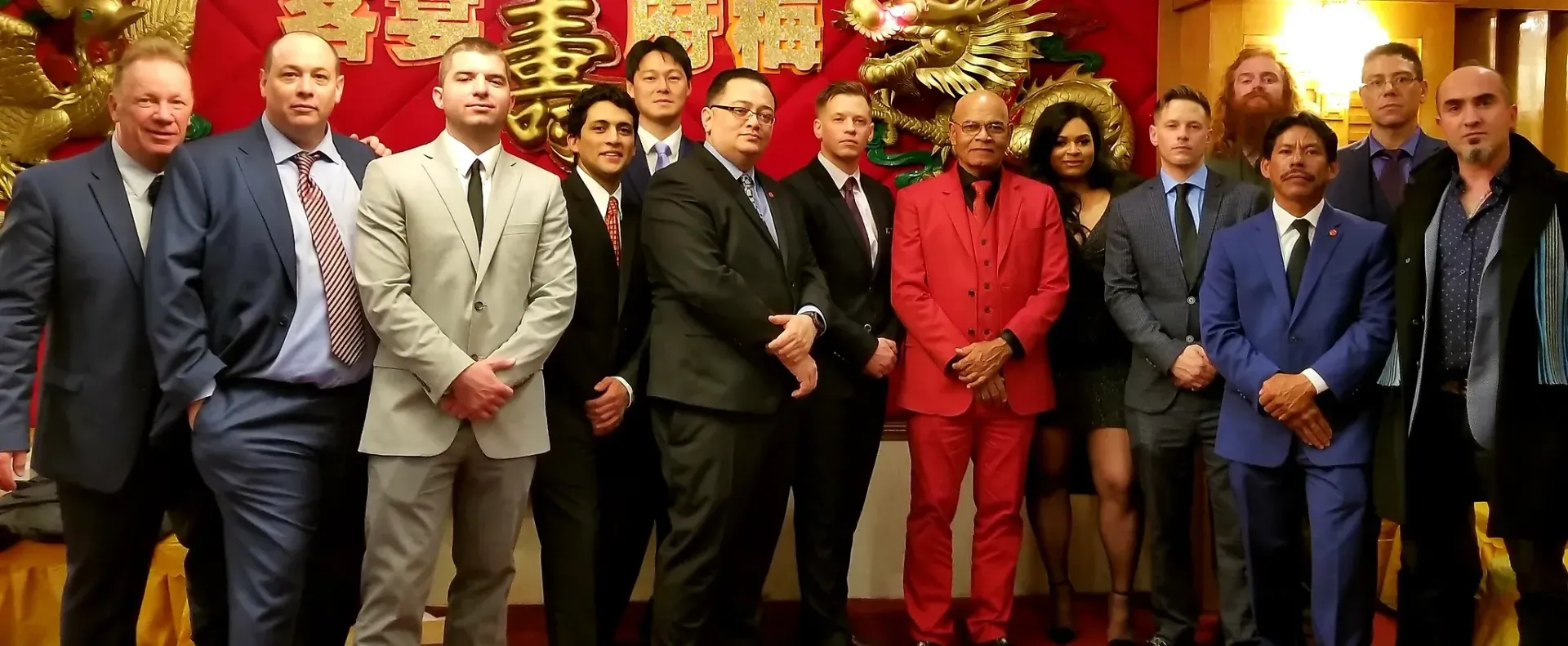 A group of men in suits and ties are posing for a picture.
