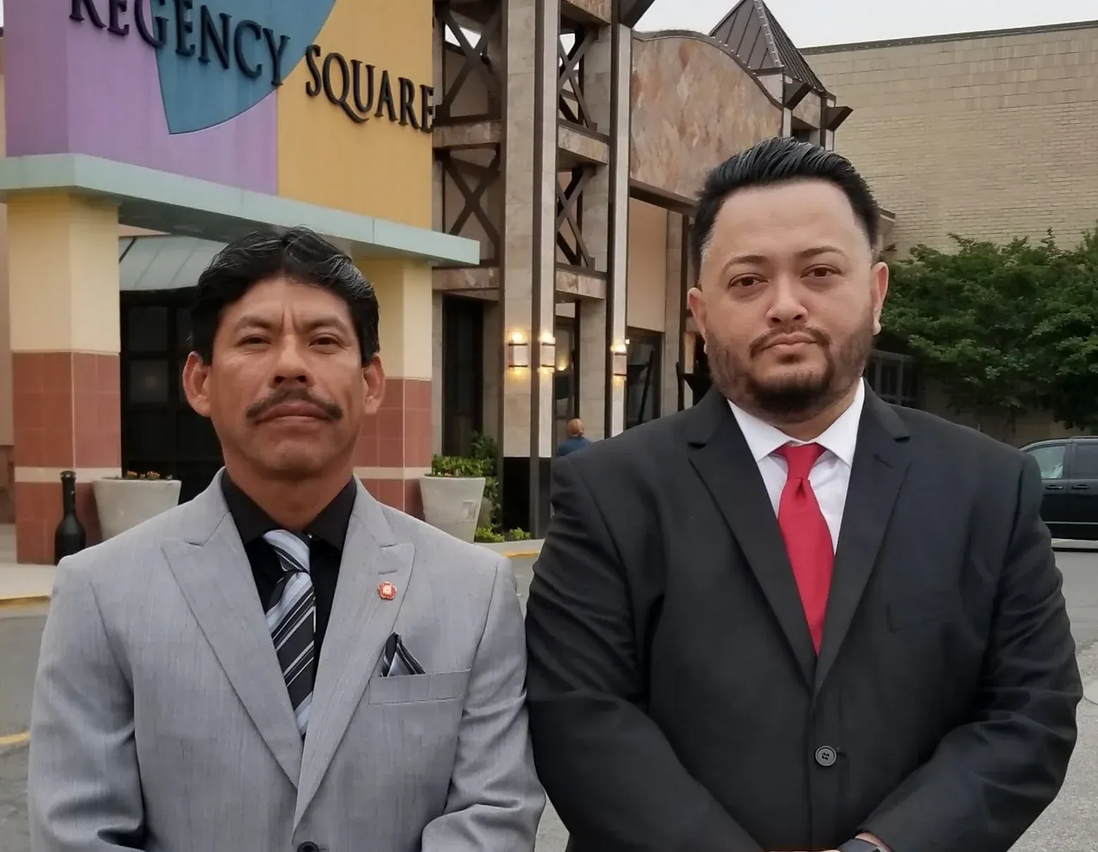 Two men standing in front of regency square