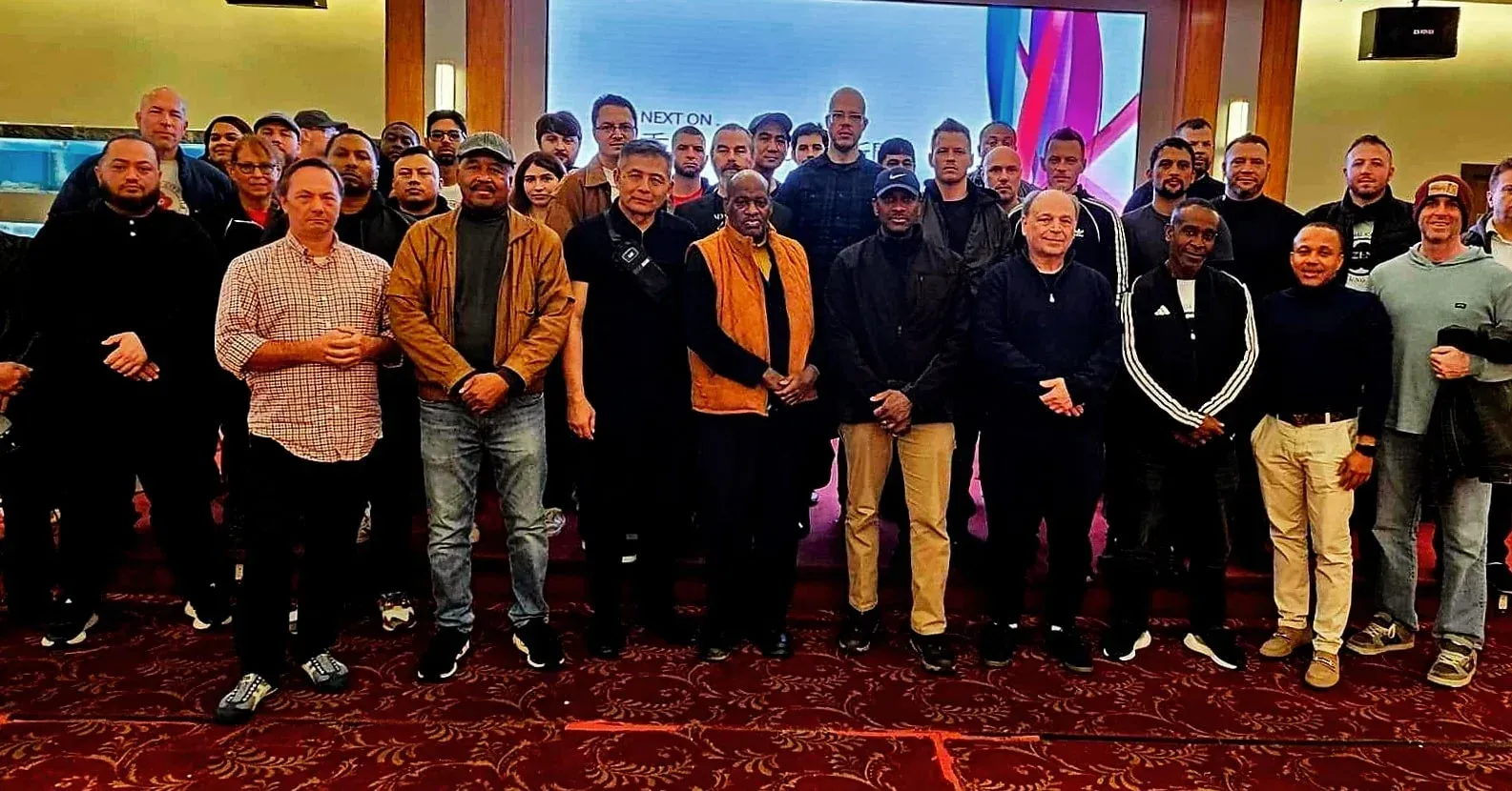 A group of men are posing for a picture in a room.