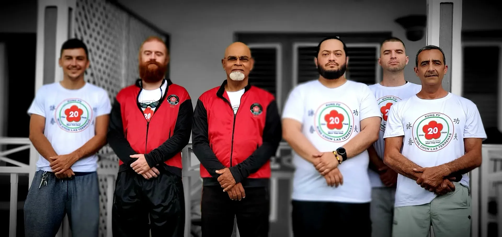 A group of men are standing next to each other on a porch.