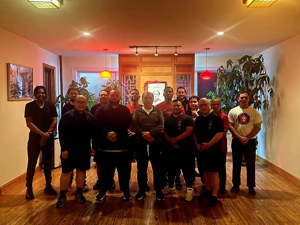 A group of men are posing for a picture in a room.
