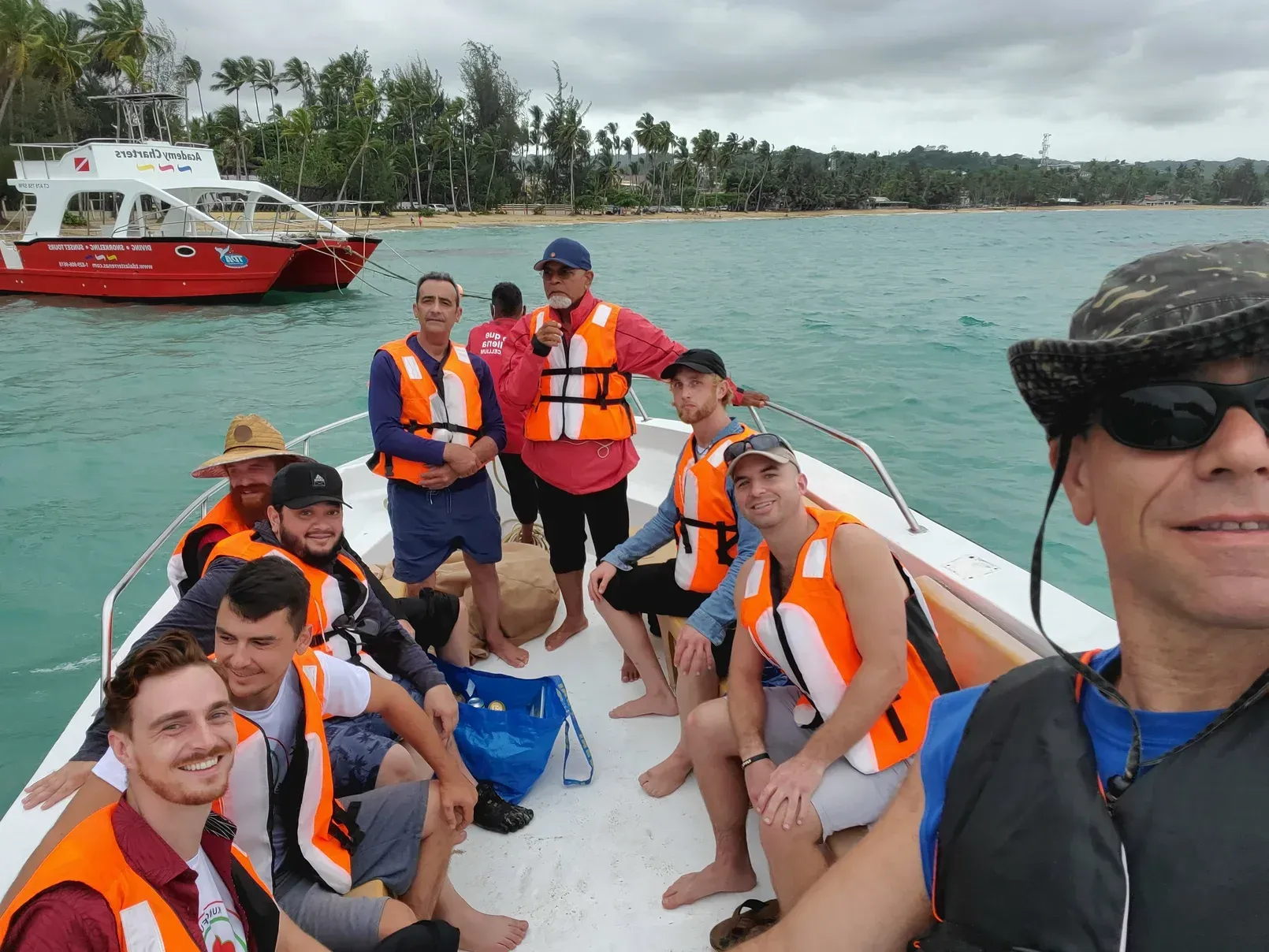 A group of people are sitting on a boat in the ocean.