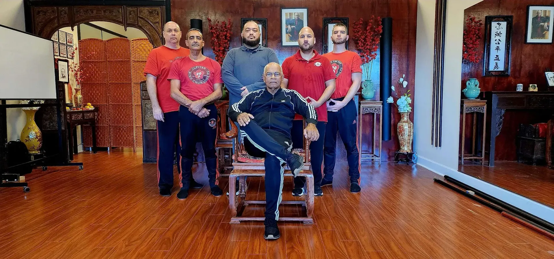 A group of men are posing for a picture in a room.