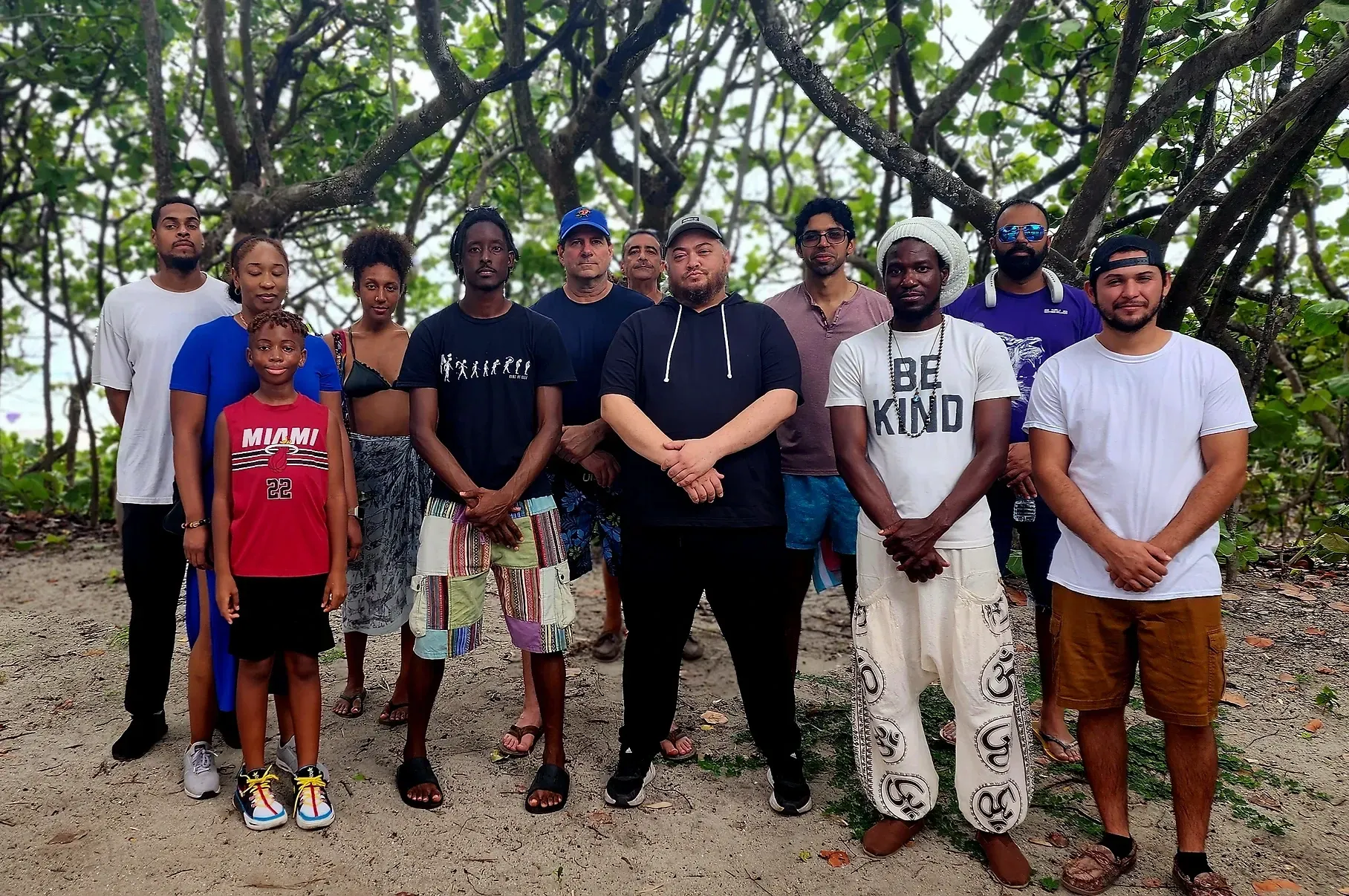 A group of people are posing for a picture in front of trees.