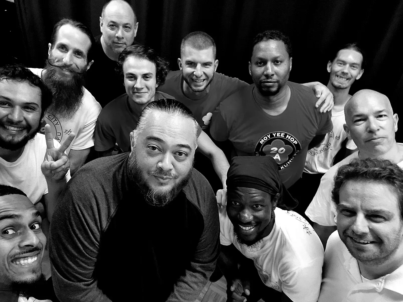 A group of men are posing for a picture together in a black and white photo.