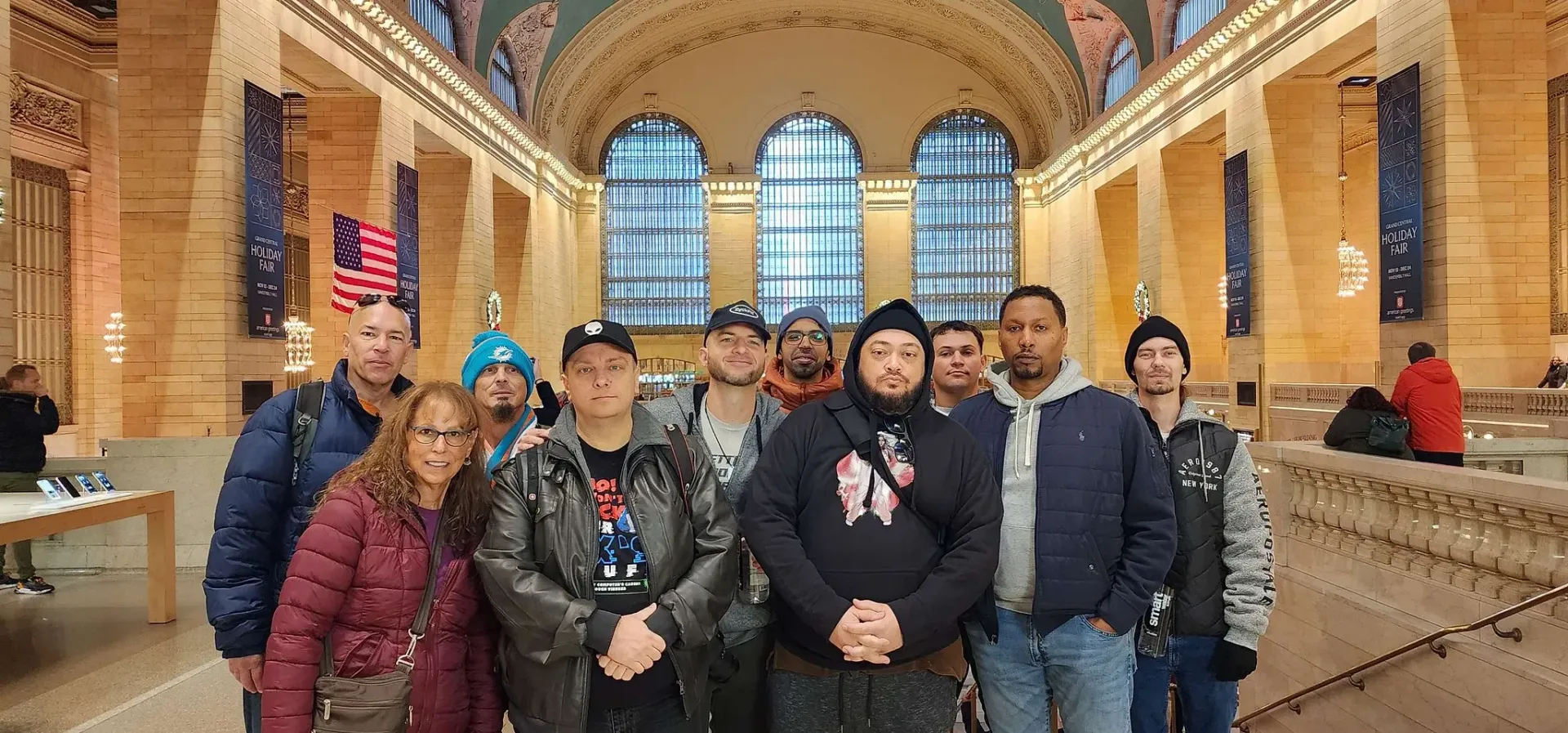 A group of people are posing for a picture in a building.