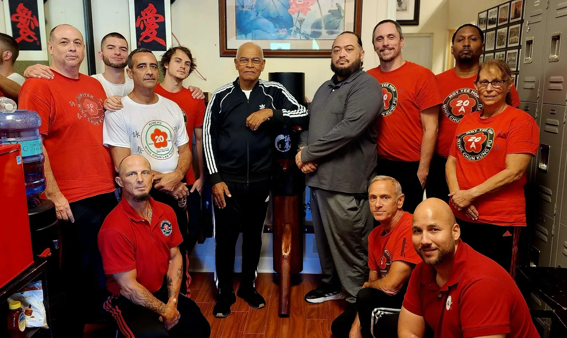 A group of people in red shirts are posing for a picture.