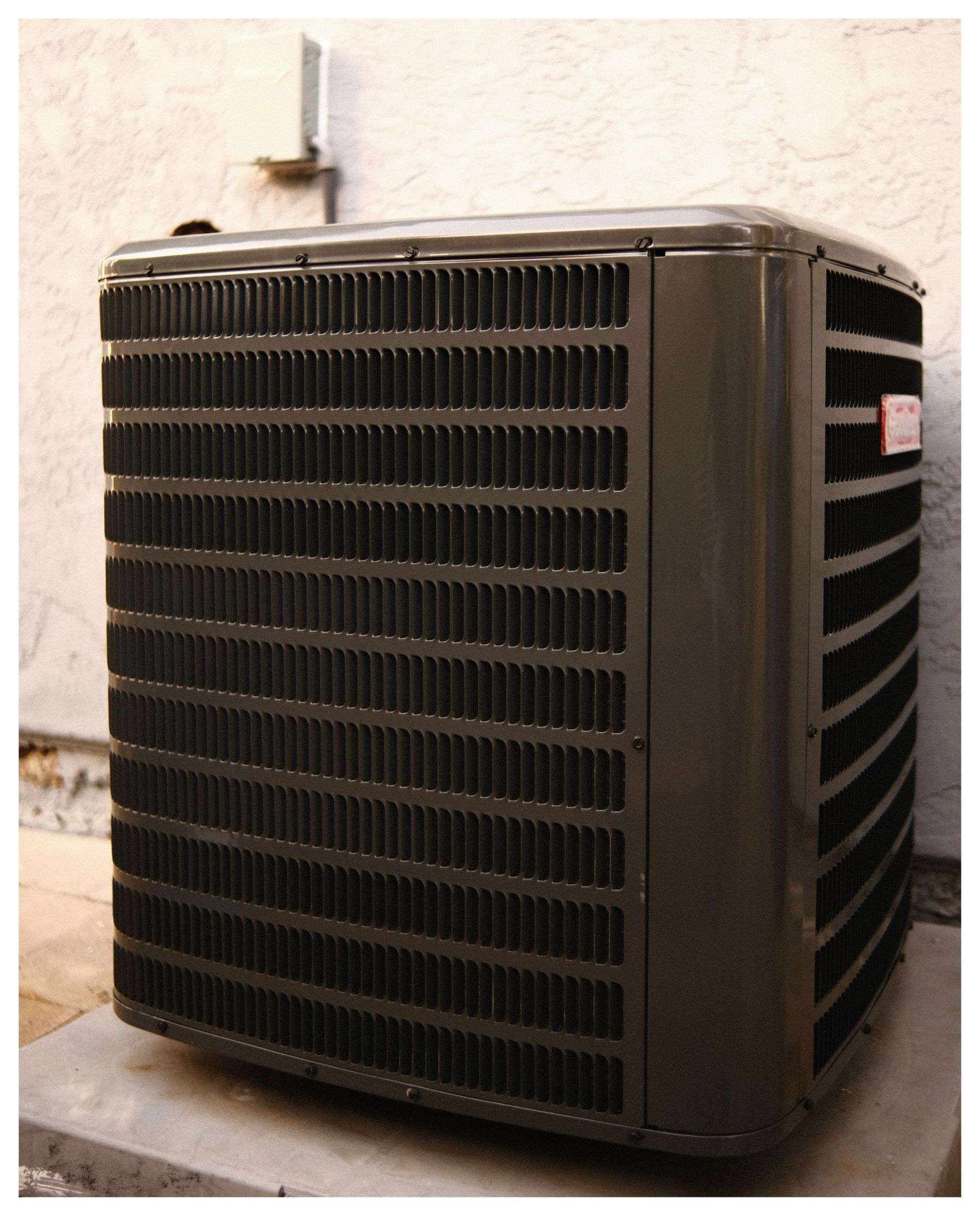 Dark gray outdoor air conditioning unit.