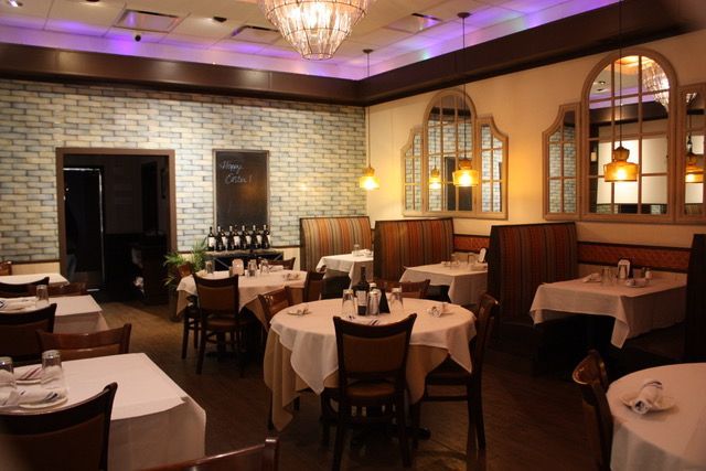 the inside of a restaurant with tables and chairs
