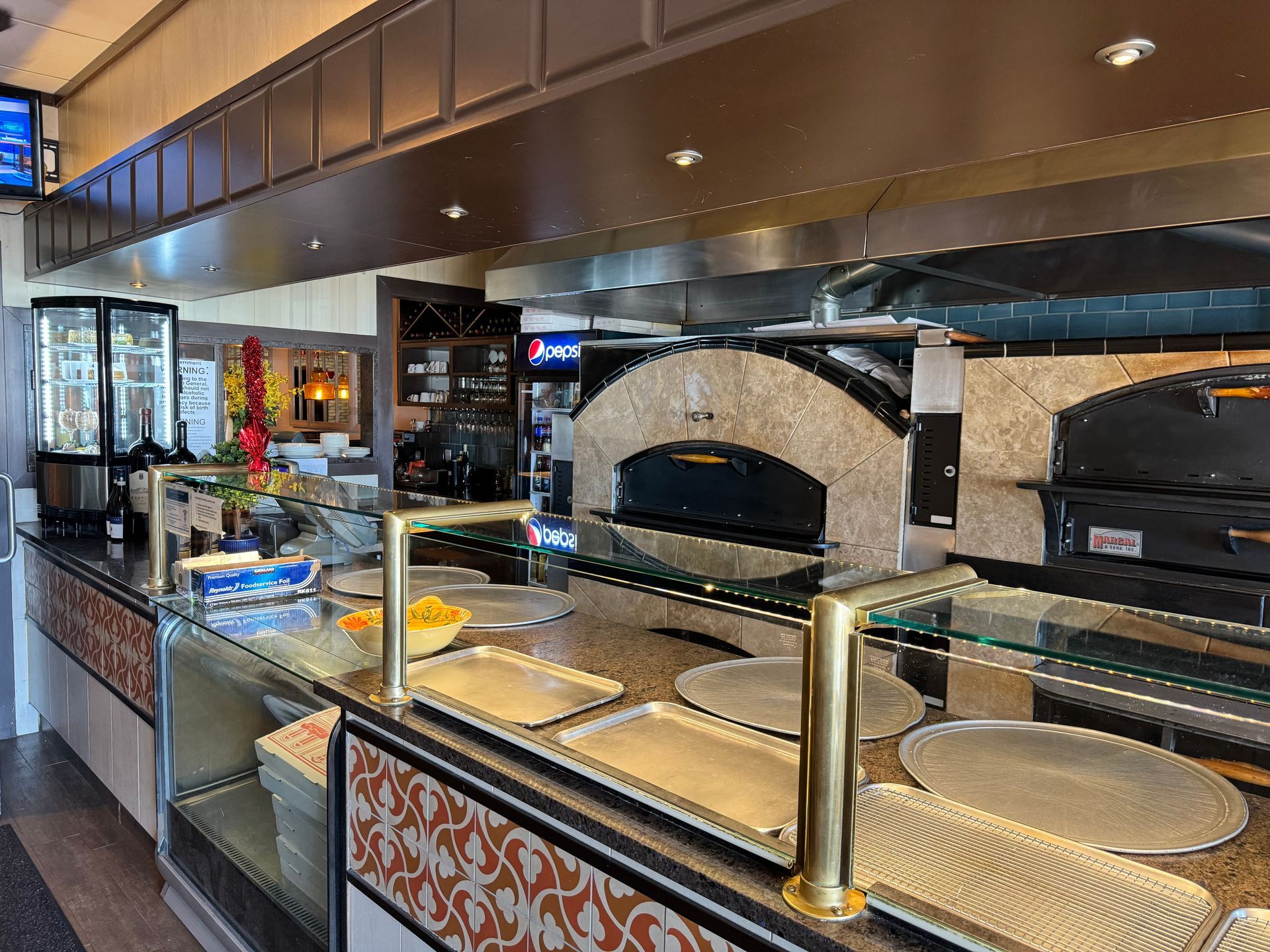 the inside of a restaurant with a tv above the counter