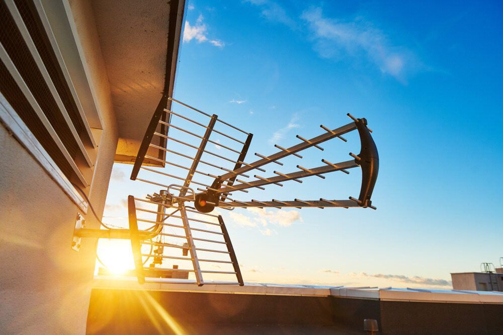 A Large Antenna is Hanging From the Side of a Building at Sunset — Audiomation in Nabiac, NSW