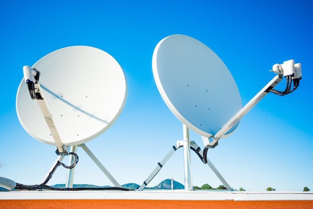 A Satellite Dish is Hanging From a Pole Against a Blue Sky — Audiomation in Nabiac, NSW