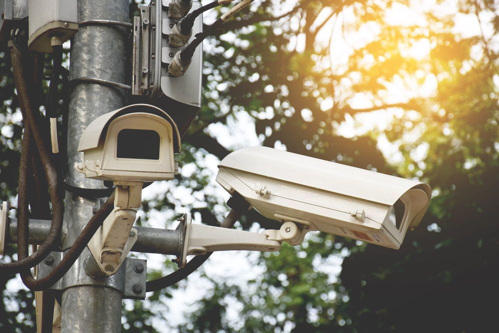 A Couple of Security Cameras Sitting on Top of a Pole — Audiomation in Old Bar, NSW