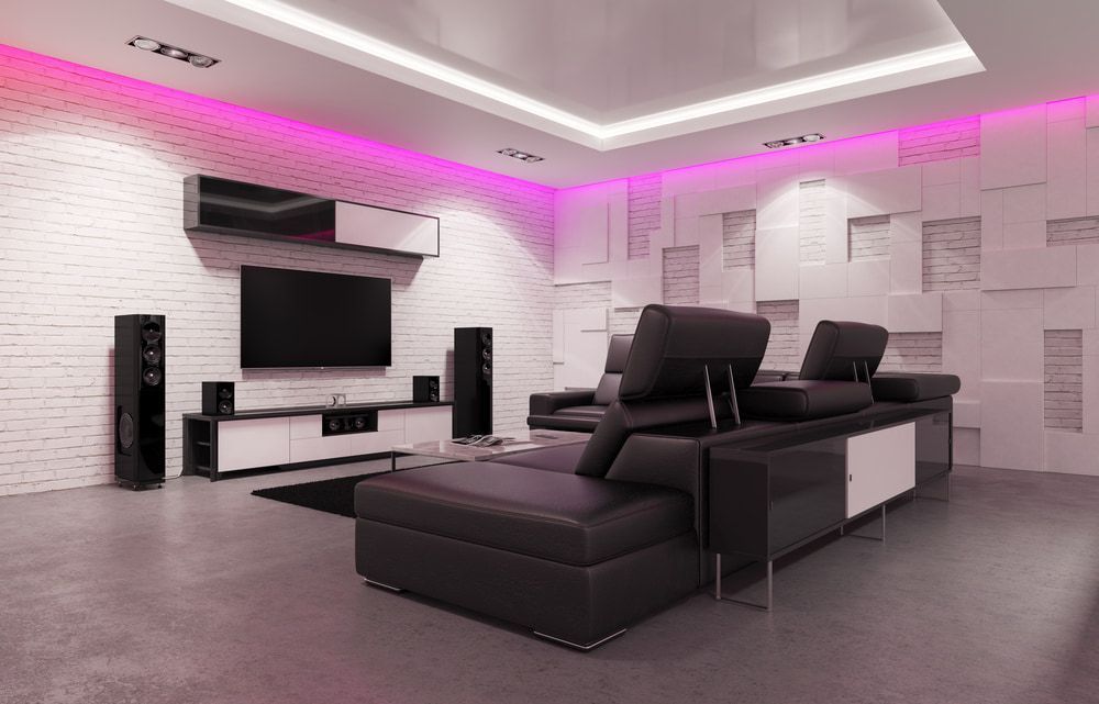 A Living Room With a Couch , Television , Speakers and a Brick Wall — Audiomation in Nabiac, NSW
