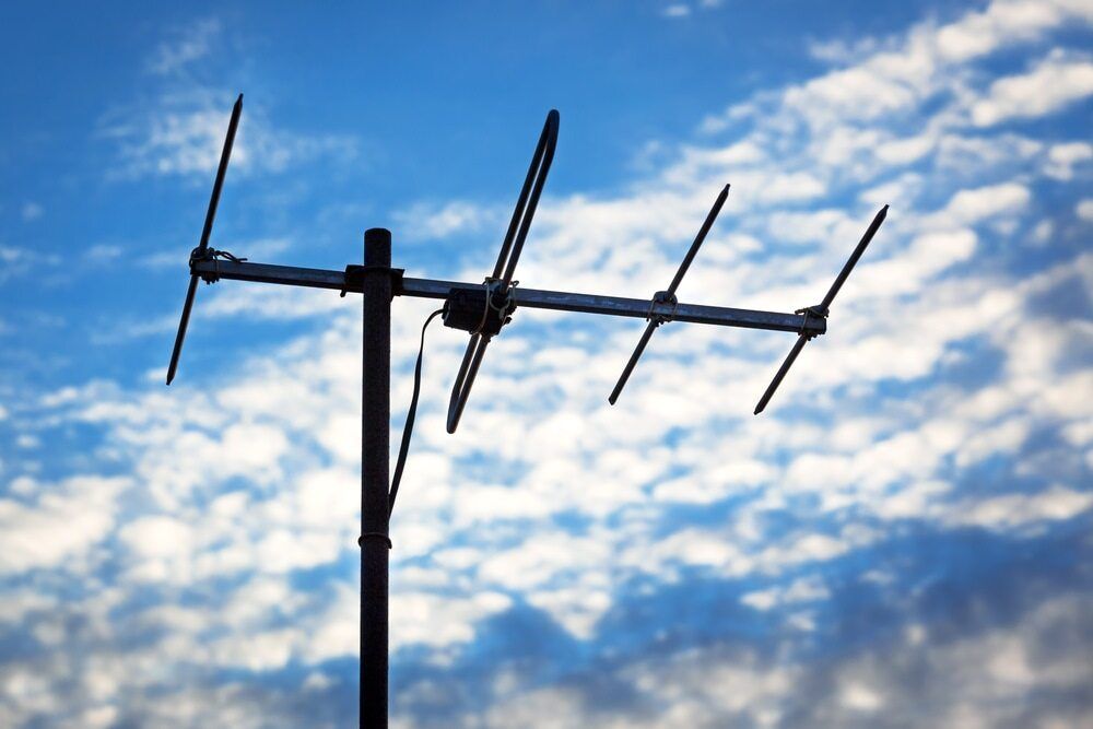 A Black Antenna Against a Blue Sky With Clouds — Audiomation in Nabiac, NSW