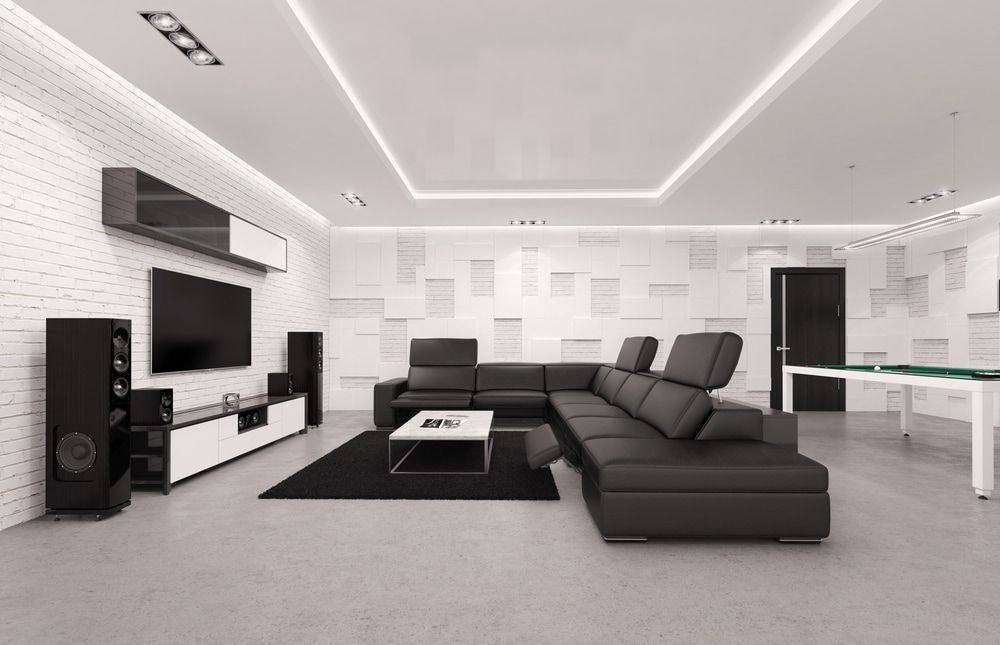 A Living Room With a Black Sectional Couch and a Flat Screen Tv — Audiomation in Pacific Palms, NSW