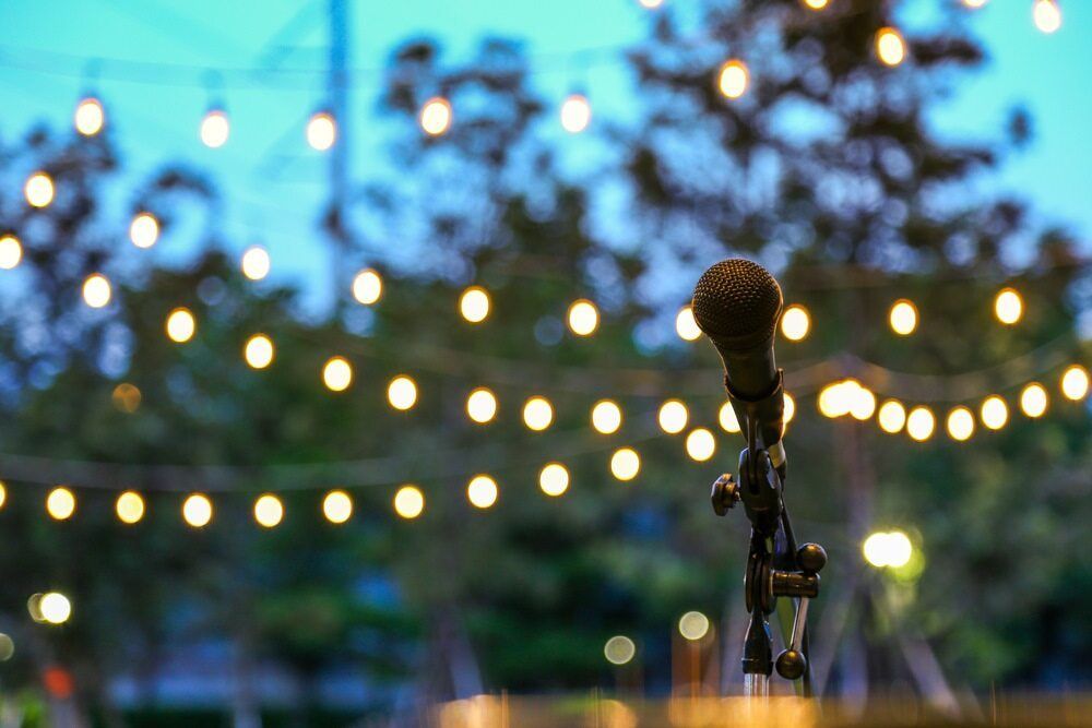 A Microphone is Sitting on a Stand in Front of a String of Lights — Audiomation in Bulahdelah, NSW