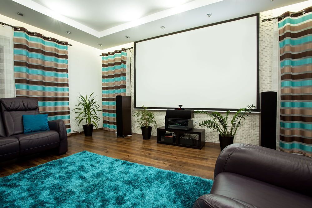 A Living Room With a Projector Screen and a Blue Rug — Audiomation in Old Bar, NSW