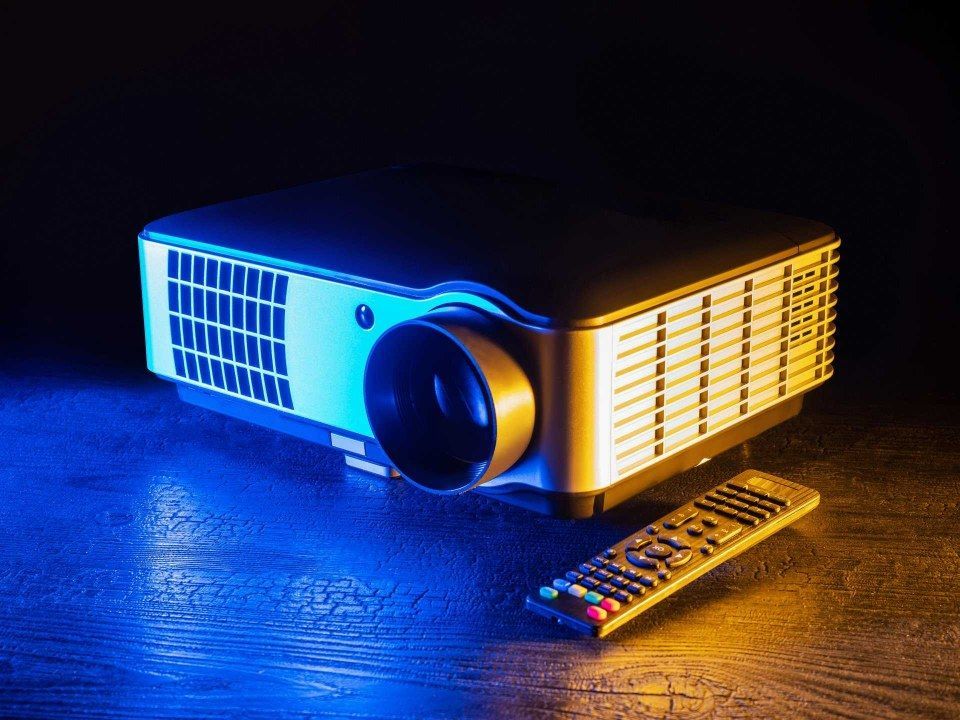A Projector is Sitting on a Table Next to a Remote Control — Audiomation in Nabiac, NSW