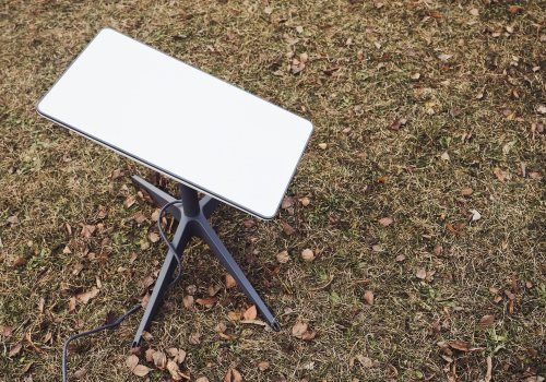 A Laptop Computer is Sitting on Top of a Table in the Grass — Audiomation in Mid North Coast, NSW