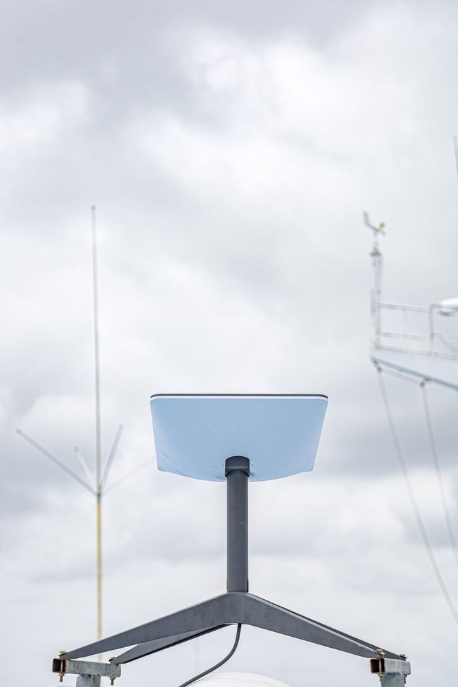 A Blue Chair is Sitting on a Tripod in Front of a Cloudy Sky — Audiomation in Nabiac, NSW